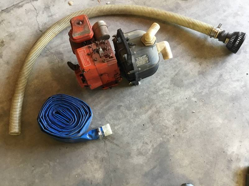 3 HP gas Homelite water pump with hose and discharge pipe