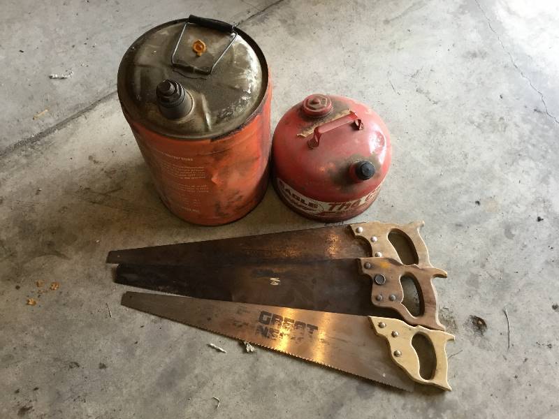 2 metal gas cans and 3 hand saws.