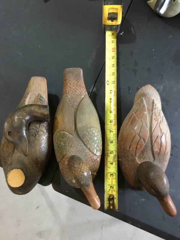 3 hand carved and painted wooden ducks.  About 14 long.