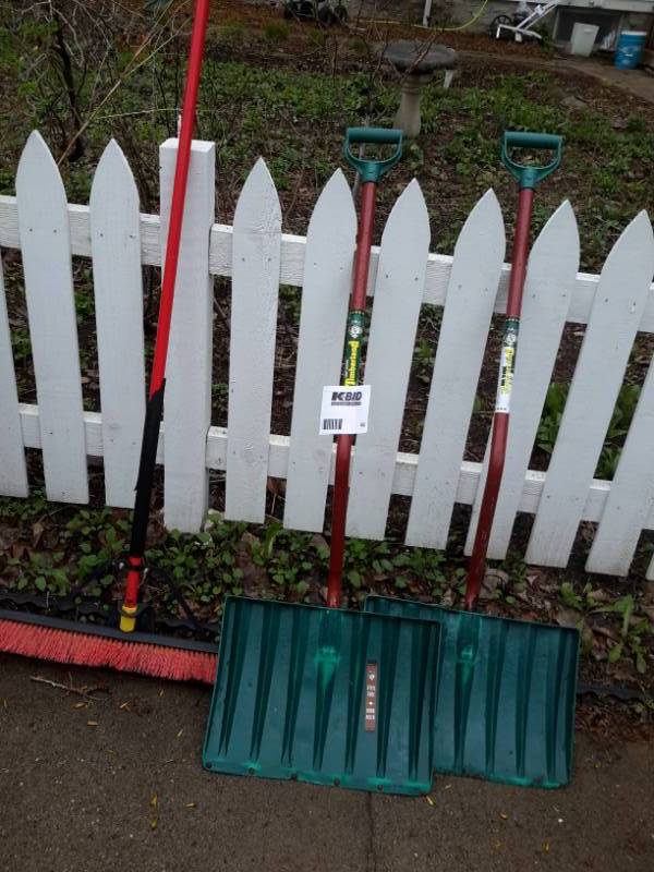 lot 62 image: 2 snow shovels and one nice Timberland push broom