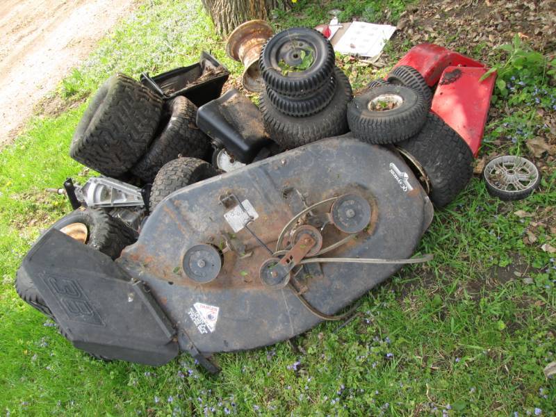 lot 34 image: Misc. lawn mower parts, 16 wheels, ...