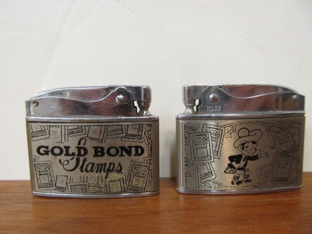 lot 23 image: Pair of Vintage GOLD BOND Stamps Advertising Cigarette Lighters