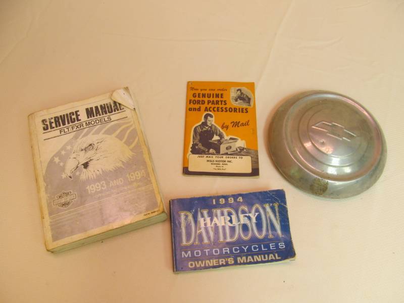 lot 135 image: 1994 Harley Manuals Vintage Chev Hubcap, Ford parts book  Mills Moron Co. 1984