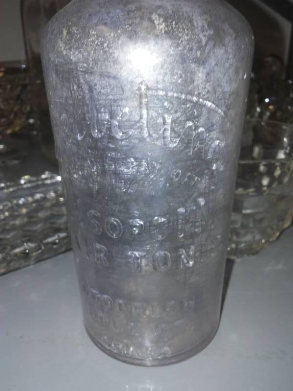 lot 242 image: Quart milk bottle, hair tonic and more.