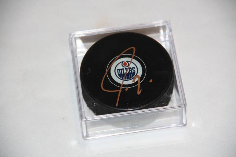 lot 69 image: Jordan Eberle Edmonton Oilers Hockey Puck Auto