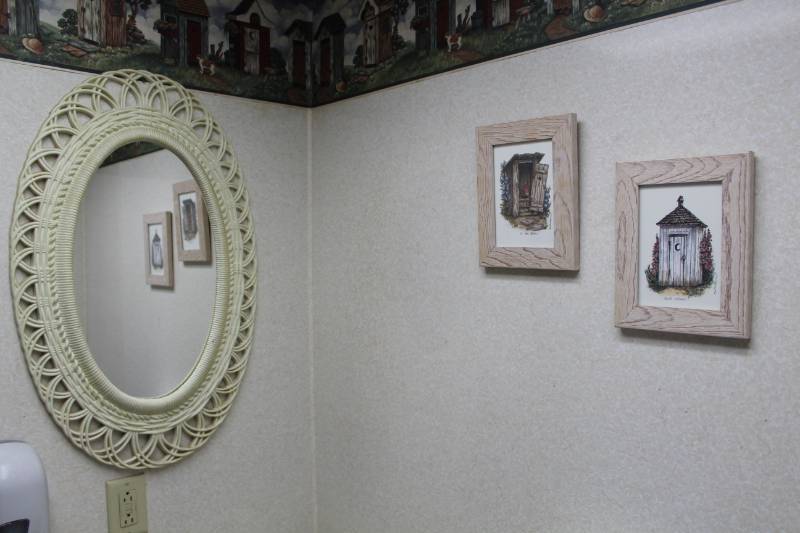 lot 100 image: Lot of (3) Bathroom Dcor - Oval Wall Mirror, Outhouse Pictures