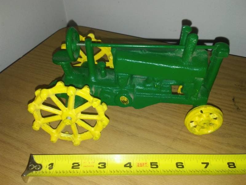 lot 112 image: Cast John Deere, tractor wheels rotate.