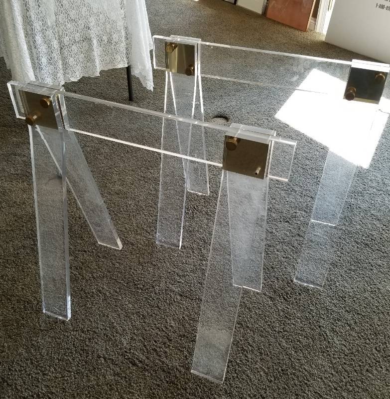 lot 38 image: Two Lucite and Brass Sawhorses