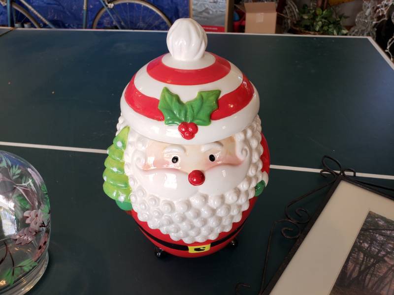 lot 33 image: NOEL Fireplace Mantle Stocking Decorations  Santa Cookie Jar  Painted Vase  Metal Frame Photograph