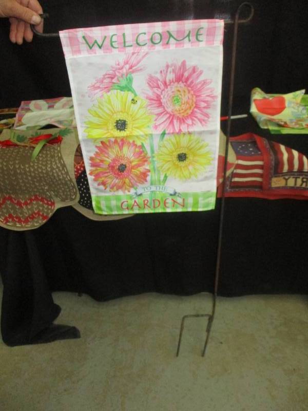 lot 43 image: Metal Shephards hook and multiple flags for every ocaasion to hang on it
