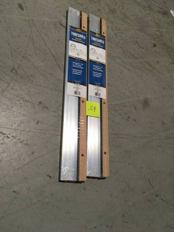 lot 34 image: M-D Building Products 4-916 in. x 36 in. Satin Aluminum and Oak Adjustable Threshold QTY 2 in Good Condition