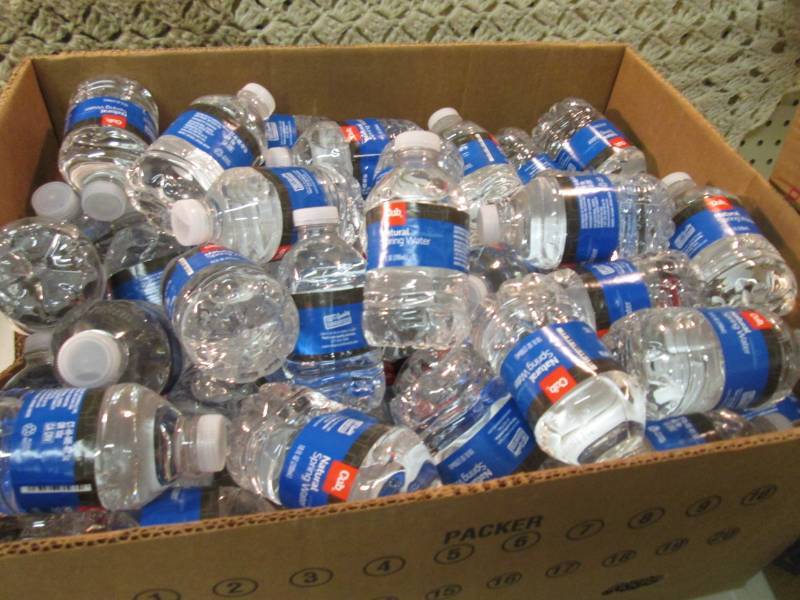 lot 69 image: Banana Box Full of 10 ounce Bottles...