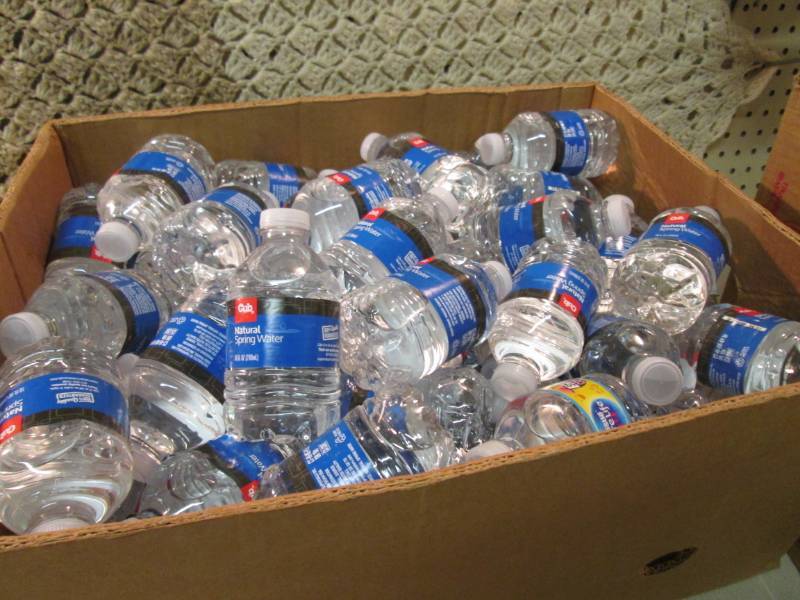 lot 70 image: Banana Box Full of 10 ounce Bottles...