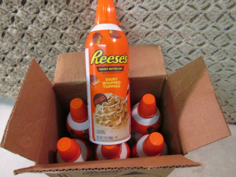 lot 215 image: Case of 6 Cans of Reeses Peanut But...
