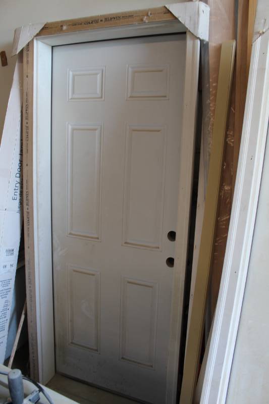lot 32 image: 6-Panel Kerfed Primed Solid Core Entry Door