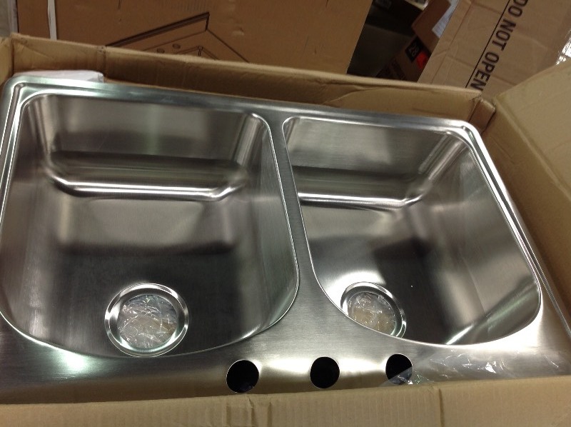 lot 105 image: Glacier Bay All-in-One Drop-In Stainless Steel 33 in. 3-Hole Double Bowl Kitchen Sink whit dent on the side please review the pictures