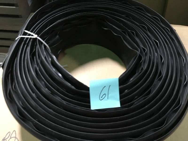 lot 61 image: Vigoro 60 ft. Lawn Edging 720 in x .5 in x 4.5 in. Black Plastic Lawn Edging not used