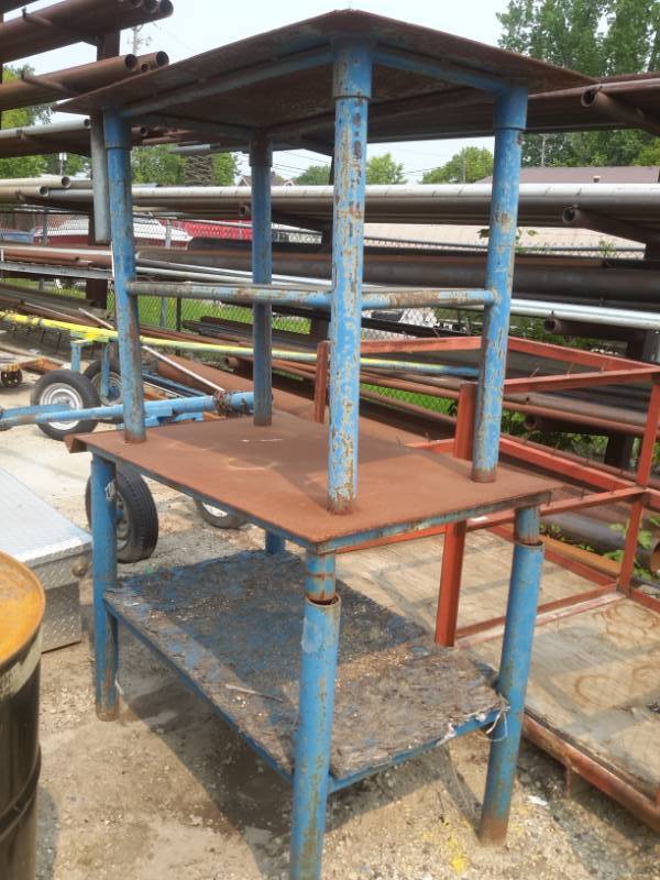 lot 66 image: 2 Solid Metal Tables, One on top of the other.. Connected    