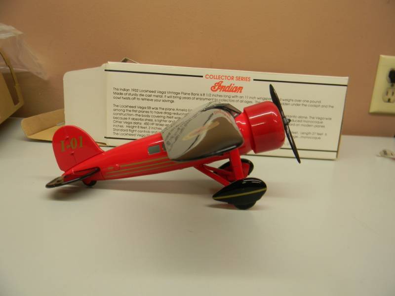 lot 34 image: COLLECTOR SERIES INDIAN MOTORCYCLES DIE CAST LIMITED EDITION AIRPLANE BANK 1932 LOCKHEED VEGA - NEW IN BOX - SEE PICTURES