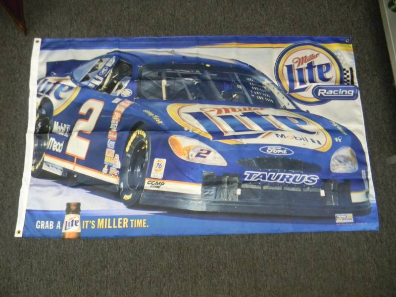 lot 44 image: MILLER LITE RACING FLAG - LIKE NEW - APPROX 58 BY 34 - SEE PICTURES