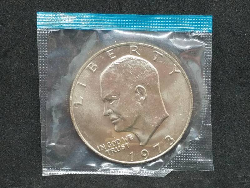lot 13 image: 1973 P IKE Dollar in Mint Wrapper