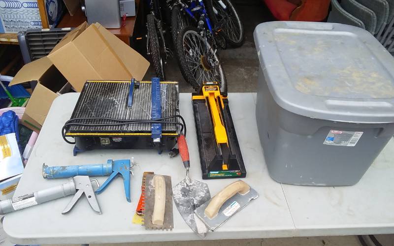 lot 9 image: Tote With Lid Tile Cutter, Tile Saw, Trowels, Caulking Guns