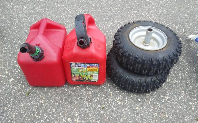 lot 23 image: 2-Gas Cans, 2-Snowblower Wheels (Like New)