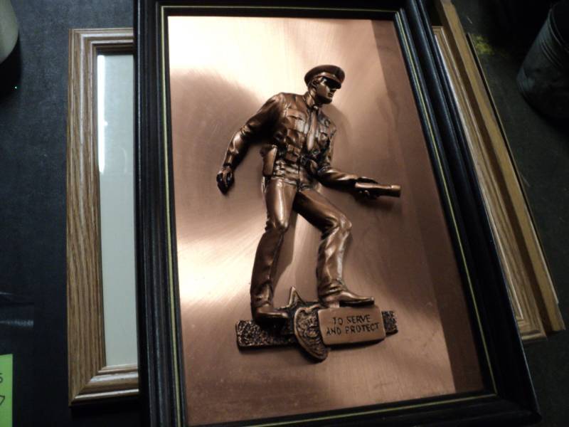 lot 18 image: To Serve and Protect Metal Scraptur...