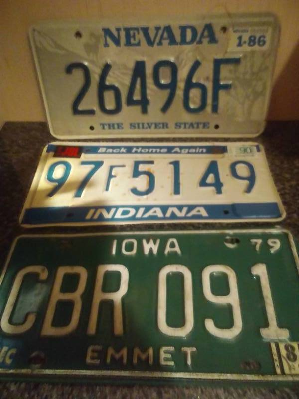 lot 21 image: 3 license plates, Iowa, Indiana, Nevada.