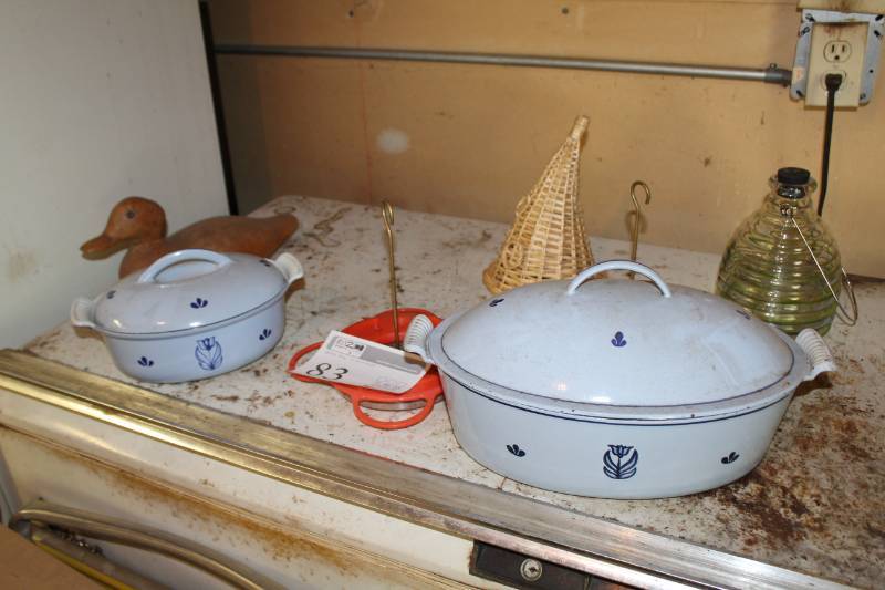 lot 83 image: Wood Duck Dcor, Glass and Wicker Table Dcor, Two Cook Pots with Lids, Serving Tray, Metal Pitcher, Metal Pot with Lid, Wicker Picnic Basket, And More