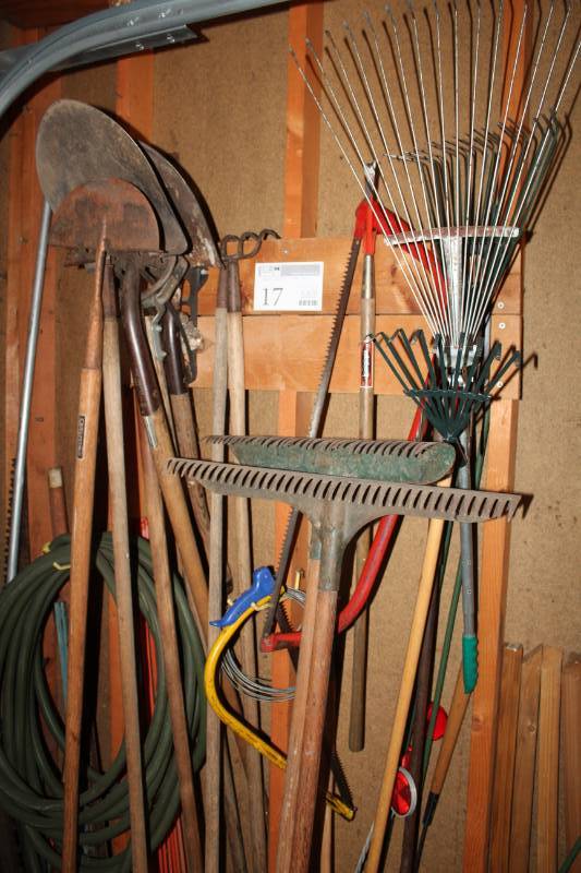 lot 17 image: Yard Tools, Stakes, Garden Hose, Spades, Various Rakes, Tree Saws