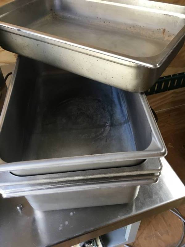 lot 142 image: Steam table pans. Full size.4 are 6 inches deep. 1 is 4 inches deep. 1 lid.