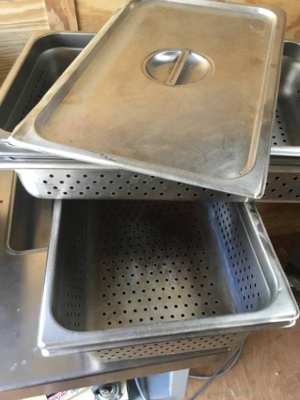 lot 143 image: lot of 5 stainless steel pans. 1 cover with holes. 2 are 6inch. 3 are 4inch.