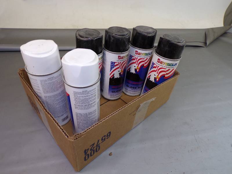 lot 32 image: 6 Cans Spray Paint  Gloss Black full, White partial