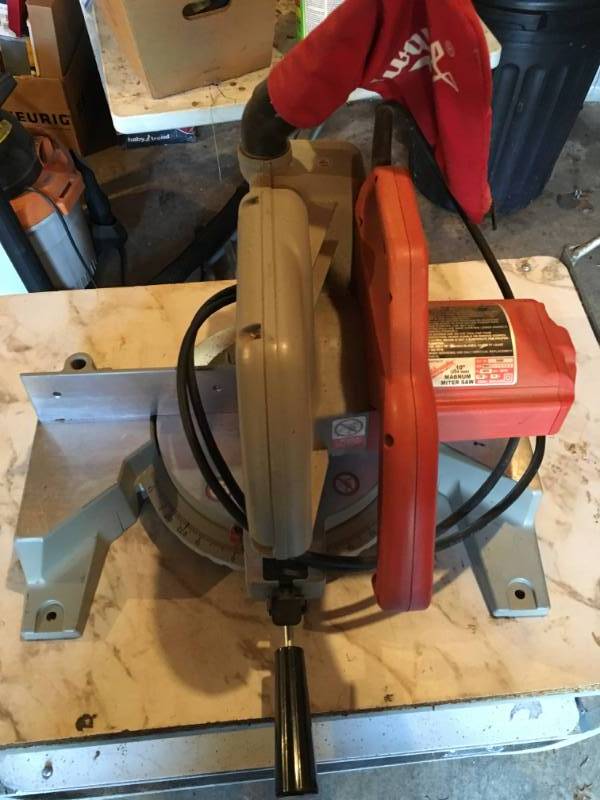 lot 12 image: Milwaukee 10 Magnum Miter Saw with cart on Casters