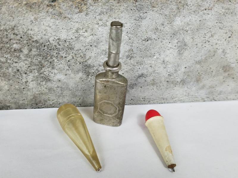 lot 210 image: 2 weighted cast line weights and 1 tin oiler for fishing reels