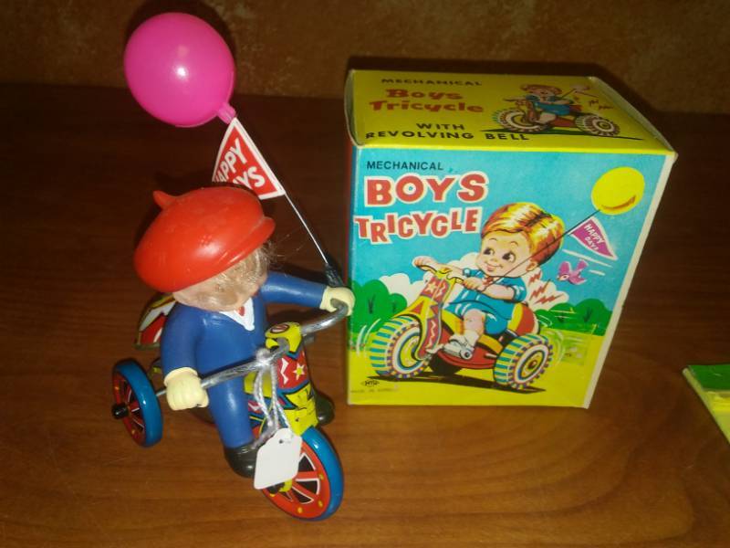 lot 52 image: Mechanical wind up boy tricycle trike with box