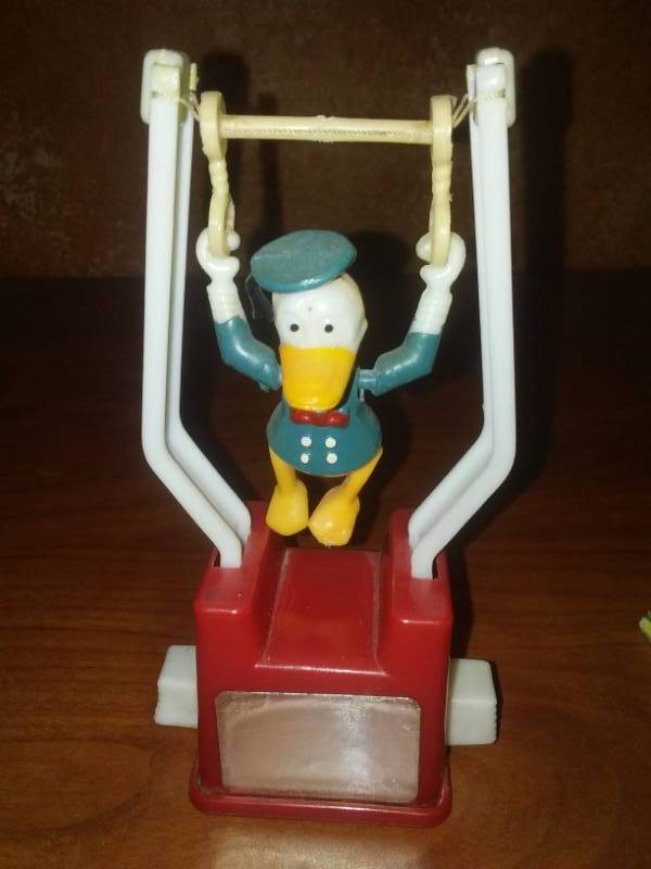 lot 53 image: Vintage Disney Donald Duck Rings, gymnast