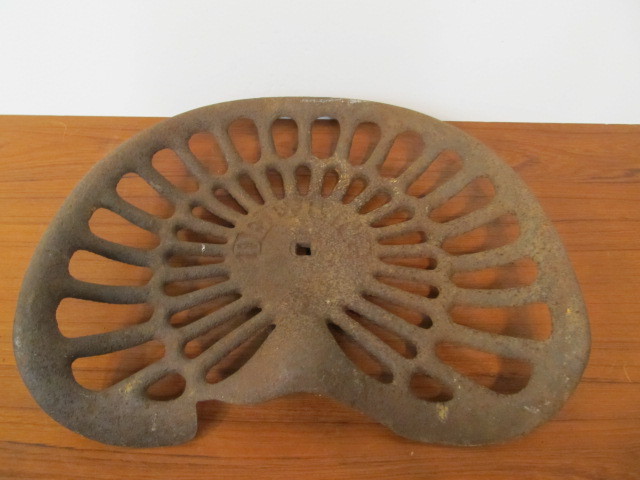 lot 73 image: Antique Cast Iron McCormick-Deering Tractor Seat