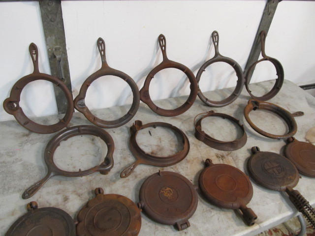 lot 299 image: Large Group of Antique Cast Iron Waffle Makers & Stands