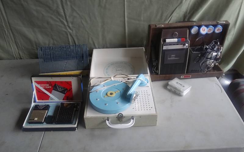 lot 16 image: Aiwa Vintage Projector, Cassette Player, Record Player. Record Rack, Transistor Radios