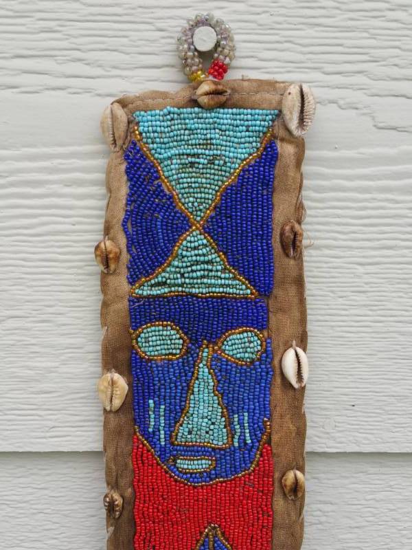 lot 414 image: Dani Tribe Animal Skin, Beads, and Shell Hanging Hut Decor
