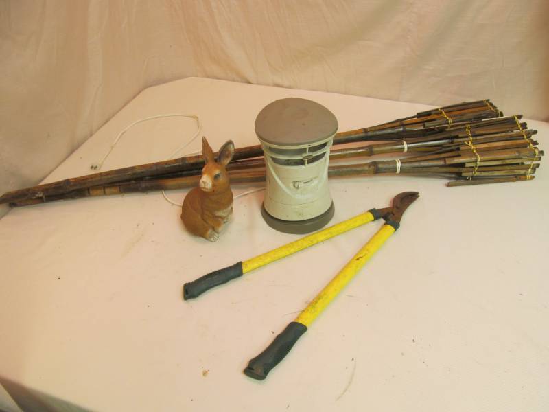 lot 102 image: No squito mosquito machine, bunny ,trimmer,(3) tiki torches