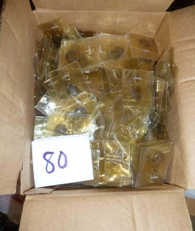 lot 80 image: a few hundred zipper pulls...