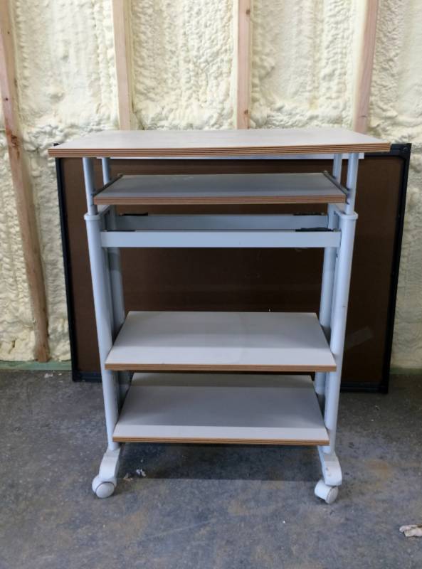 lot 24 image: Multi-Use 4 Tier Shelving Unit On Wheels - Make a great mobile Workstation  Bottom shelves are adjustable - Great Condition