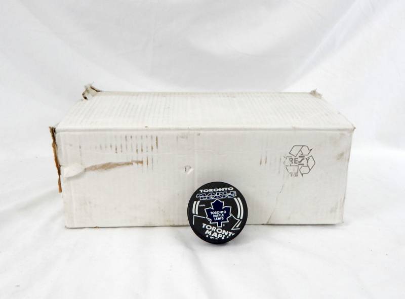 lot 100 image: Lot of Toronto Maple Leafs NHL Team Pucks