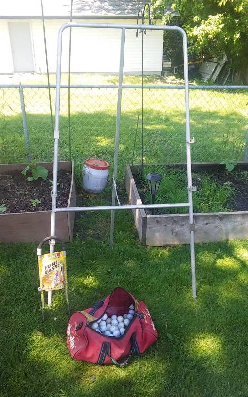 lot 19 image: Large Easel 36x70, Bag Of Golf Balls, Balance Buddy For Bike