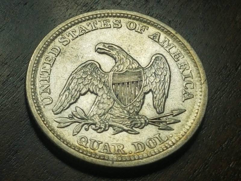 lot 41 image: 1856 SEATED LIBERTY QUARTER AU58 (looks BU in hand)