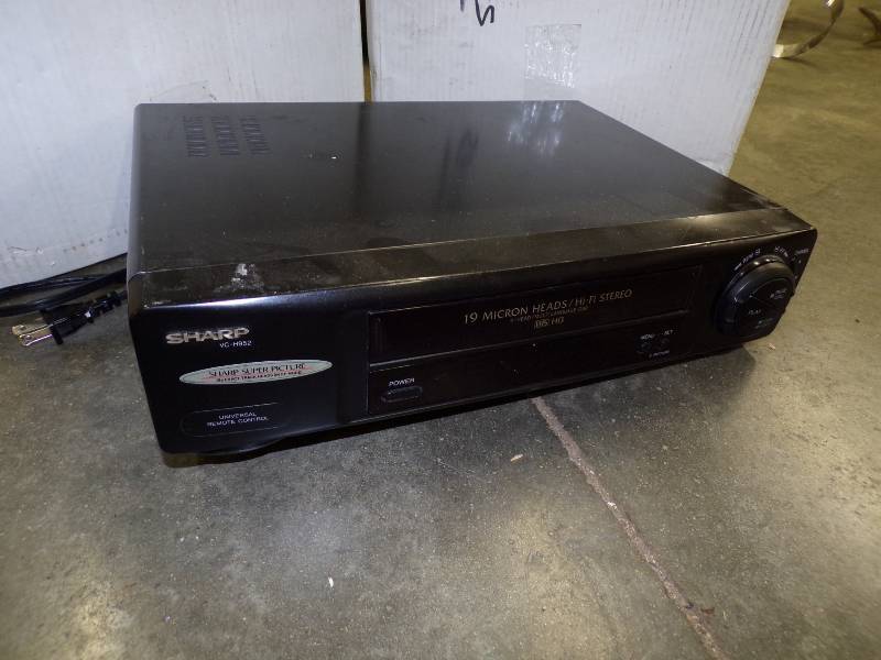 lot 64 image: VHS Player with 2 Large Boxes of VHS Movies