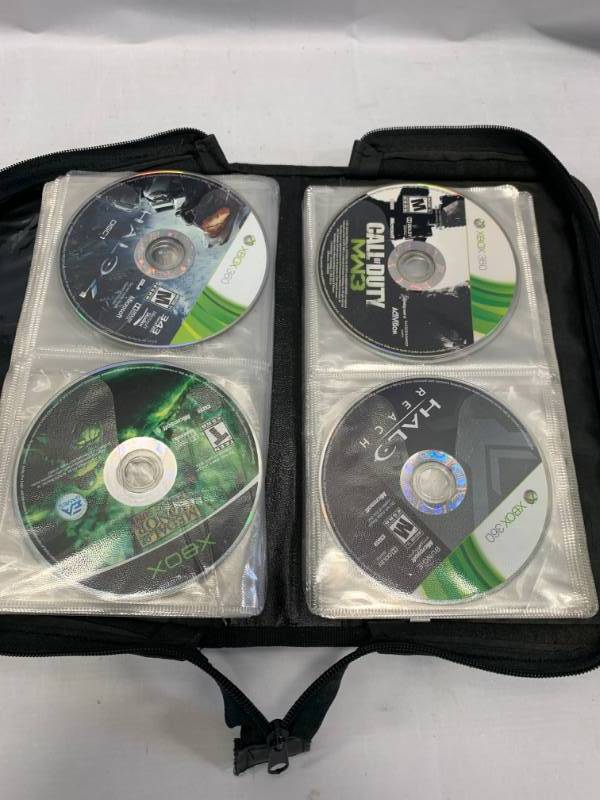 lot 93 image: Book with 20 XboxXbox 360 Games